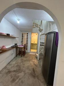 a kitchen with a refrigerator and a table in it at Apartamento no Centro de Londrina in Londrina