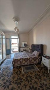 a bedroom with a bed and a table and a window at Appartement au cœur d'Alger in Kasbah