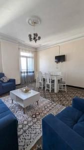 a living room with a blue couch and a table at Appartement au cœur d'Alger in Kasbah