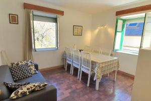 a living room with a table and chairs and a couch at Casa Los Quinos in Bielsa