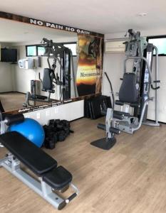 a gym with two treadmills and two machines at Hotel Natal Plaza com piscina, academia, 100m da praia de Ponta Neg in Natal
