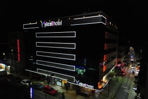 a building with a sign on the side of it at night at Yucel Hotel in Usak