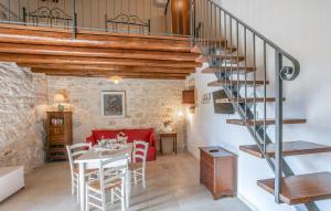 a living room with a table and a spiral staircase at Stunning Home In Ragusa With Wifi in Ragusa