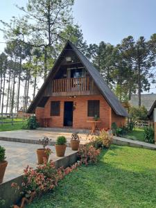 a house with a gambrel roof with a porch at Sonnenblumen chalet in Mafra +14 photos