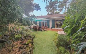 a house with a table and chairs in the yard at Gorgeous Home In Saint-Brevin-Les-Pins in Saint-Brevin-les-Pins