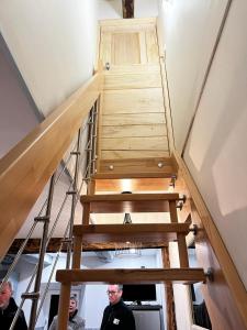 a staircase in a house with people standing around it at La Marquise in Saint-Côme-dʼOlt