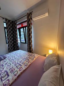 a small bedroom with a bed and a window at Comfort Guest Rooms in Plovdiv +17 photos