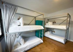 two bunk beds in a room with a mirror at Marietta - House of Social Travellers in Bogotá