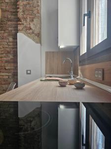 a kitchen with a counter top with a sink at La estación in Málaga