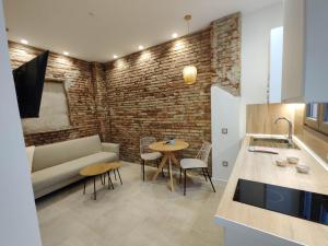 a living room with a couch and a table at La estación in Málaga +49 photos