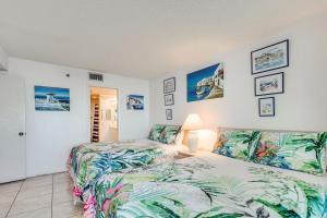 a bedroom with two beds and a lamp at Balcony and Resort Amenities Gulf Coast Escape! in Hudson