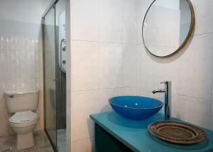 a bathroom with a sink and a toilet and a mirror at Marietta - House of Social Travellers in Bogotá +47 photos