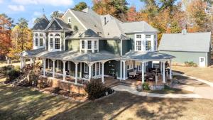 an aerial view of a green house with white windows at Chateau d' Amour - Where Love & Luxury Meet in Wake Forest