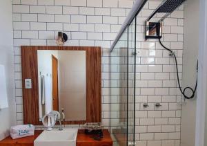 a bathroom with a sink and a shower with a mirror at Pérola do Tree Bies Resort in Entre Rios