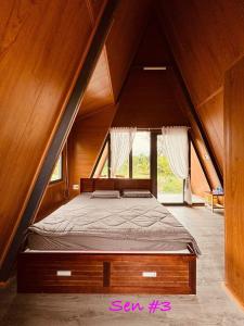 a bedroom with a bed in an attic at Huong Sen Garden lodge in Xóm Bãi Trại