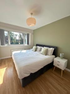 a bedroom with a large bed and a window at The Olive House - 4 Bedroom, Sleeps 8, Contractors Welcome in Middlesbrough
