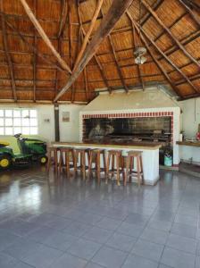 a room with a fireplace and wooden tables and chairs at Quinta Ferreyra in Villa Paranacito