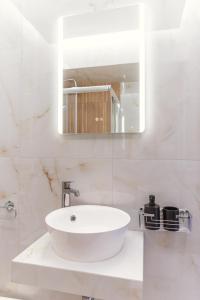 a white bathroom with a sink and a mirror at La Bella Casa Thessaloniki in Thessaloniki +29 photos