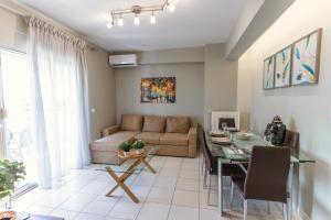 a living room with a couch and a table at La Bella Casa Thessaloniki in Thessaloniki