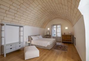 a bedroom with a bed and a brick ceiling at Dimora Bianca Aurora in Ortelle