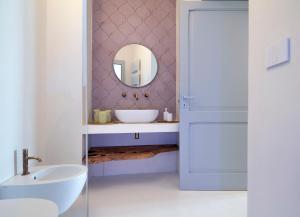a bathroom with a sink and a mirror at Dimora Bianca Aurora in Ortelle +37 photos