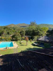 a yard with a swimming pool and a house at Vista da Montanha in Petrópolis