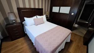 Łóżko lub łóżka w pokoju w obiekcie Apartamento AGRELO