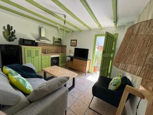 a living room with a couch and a table at La Lozana - Río Verde in Jete