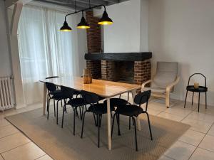 a wooden table and chairs in a living room at La Maison d Elodie in Vierzon