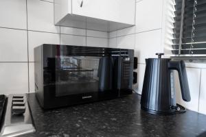 a microwave oven sitting on top of a kitchen counter at Lakeview Haven in Queenstown