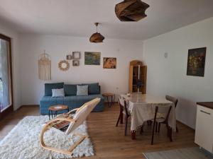 a living room with a table and a blue couch at Mountain magic house - Matka in Skopje