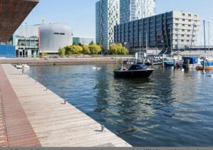 a small boat in the water next to a dock at In Almere, Close to Amsterdam in Almere
