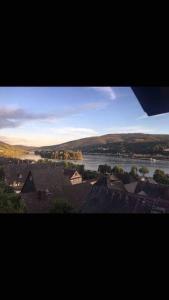a view of a city with a river and buildings at House Four Castles View - A whole House for you!! in Lorch am Rhein