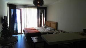 a bedroom with a bed and a christmas tree at Studio Apartment in New Gudauri 2 in Gudauri