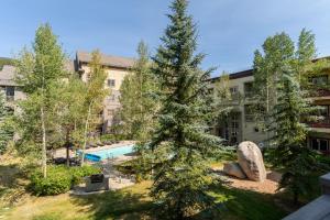 an apartment building with a swimming pool and trees at Expedition Station 8598 in Keystone
