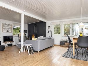 a living room with a couch and a table at 5 person holiday home in Thyholm-By Traum in Thyholm