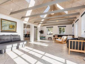 a living room with a couch and a table at 10 person holiday home in Fur-By Traum in Fur