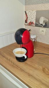 a coffee maker is pouring coffee into a cup on a counter at Studio Centre Historique in Vannes