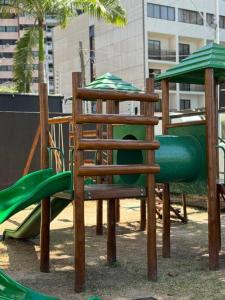 a playground with a wooden chair and a slide at landscap Meireles Fortaleza in Fortaleza