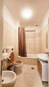 a bathroom with a toilet and a sink and a tub at Rooms4you 2 in historic center of Braga in Braga +53 photos