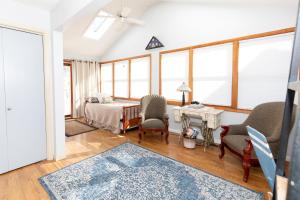 a bedroom with a bed and a table and chairs at Bluebirds Road to Happiness in Vermilion
