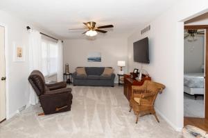 a living room with a ceiling fan and a couch at Bluebirds Road to Happiness in Vermilion