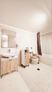 a bathroom with a sink and a toilet and a tub at Rooms4you 2 in historic center of Braga in Braga