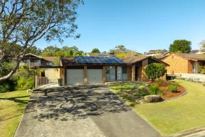 a house with solar panels on the roof at Colloden Beach House by Experience Jervis Bay in Vincentia