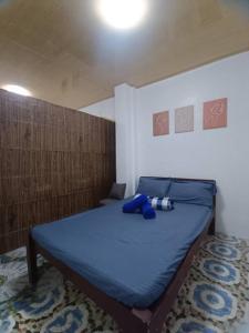 a bedroom with a bed with a blue comforter at CM Heights Homey 2 bedrooms in General Santos