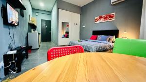 a room with a bed and a table and chairs at Montana Suites, Empire Damansara in Petaling Jaya