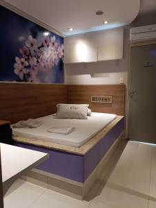 a bed in a room with a painting on the wall at motel chanty in Piracicaba