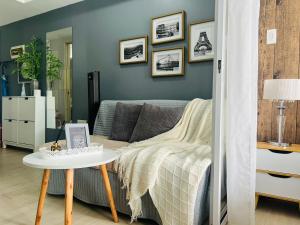 a living room with a couch and a table at The Bahamas & Maldives Suites at Azure Residences near Manila Airport in Manila