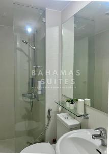 a bathroom with a shower and a toilet and a sink at The Bahamas & Maldives Suites at Azure Residences near Manila Airport in Manila