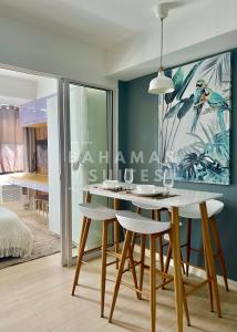 a dining room with a table and some chairs at The Bahamas & Maldives Suites at Azure Residences near Manila Airport in Manila